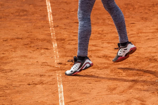 Girl serving on a tennis match