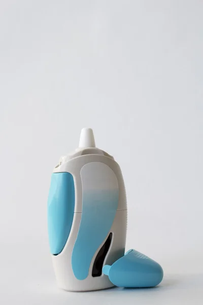 Nasal spray with blue spray container isolated on background