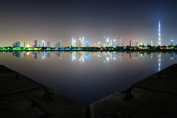 Amazing night dubai downtown skyline with tallest skyscrapers and beautiful Jumeirah beach reflection, Dubai, United Arab Emirates