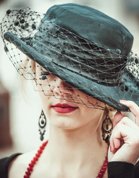 Young pretty sexy lady in black vintage hat outdoor