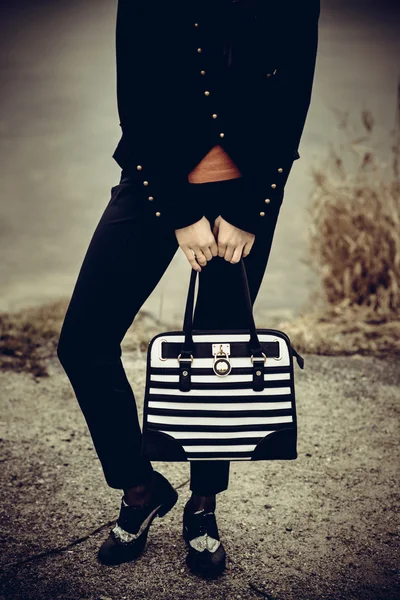 Girl with black and white bag in the hands