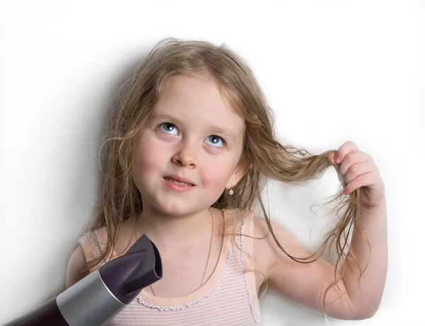 Girl dries hair the hair dryer