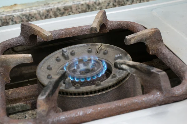 Detail of a burning gas stove with blue flames