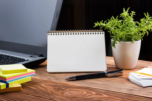 Home workplace with computer, blank notepad, copy space close up