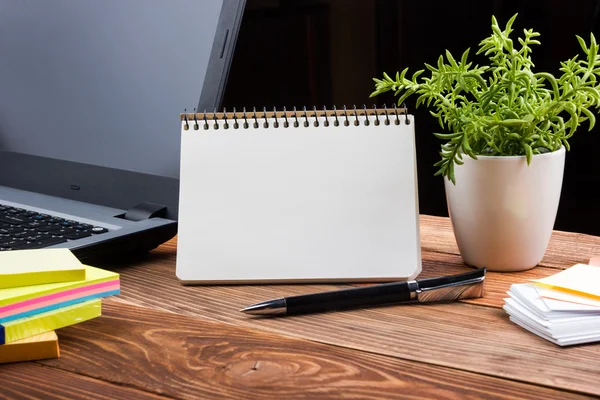 Home workplace with computer, blank notepad, copy space close up