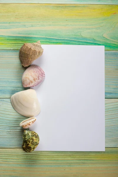 Summer sea vacation mockup background. Notebook blank page with Travel items on blue green wooden table. Sea shells, pebbles, top view.