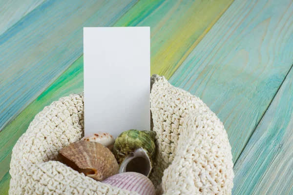Business card, summer sea vacation mockup background. Notebook blank page with Travel items on blue green wooden table. Sea shells, pebbles, top view.