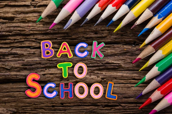 Back to School desk table top view, words on grunge old wooden board background. Education concept. Time for learning.