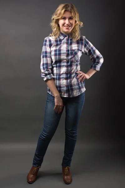 Full length Pretty casual young fashion model in blue jeans posing