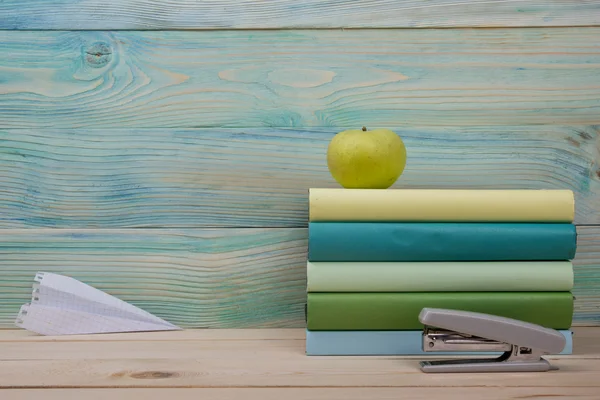 Back to school. Stack of colorful books on wooden table. Copy sp