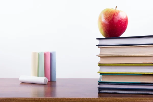 A stack of colorful books and open book. Ideas for business and self-development isolated on white background with empty place for your text