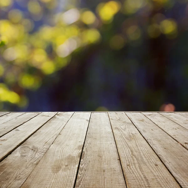 Wooden perspective floor with planks on blurred natural summer b