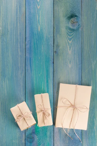 Festive present boxes with ribbon on turquoise painted wooden background. Place for text. Selective focus.