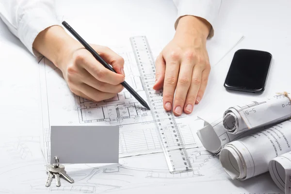 Architect working on blueprint. Architects workplace - architectural project, blueprints, ruler, calculator. Construction REAL ESTATE concept. Engineering tools. Top view.