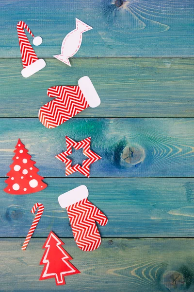 Christmas rustic background - vintage planked wood with Christmas fir tree and free text space. Top view of snowflakes, gift boxes, decoration on blue grunge wooden deck table. Winter holidays concept