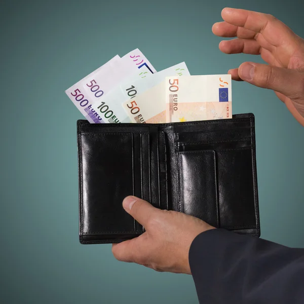 Businessman counts money in the wallet