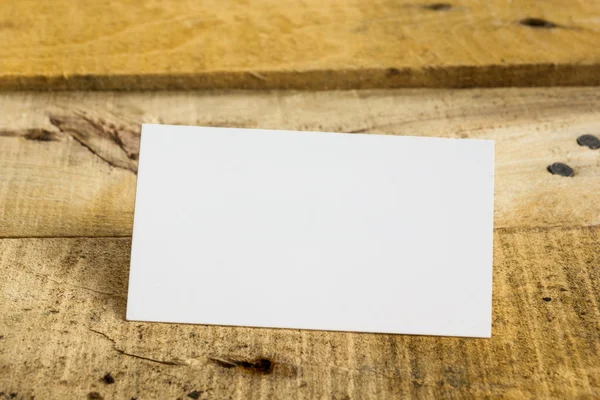 White blank business visit card, gift, ticket, pass, on wooden table.