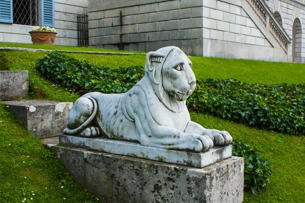 Bellagio city on Lake Como, Italy. Lombardy region. Italian famous landmark, Villa Melzi Park. sculpture of lieing lion