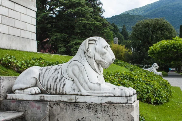 Bellagio city on Lake Como, Italy. Lombardy region. Italian famous landmark, Villa Melzi Park. sculpture of lieing lion