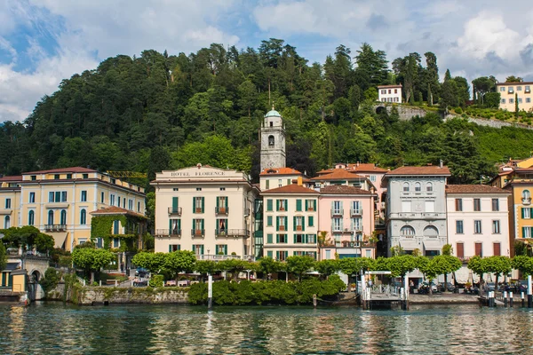 BELLAGIO ON LAKE COMO, ITALY, JUNE 15, 2016. View on coast line of Bellagio city on Lake Como, Italy. Italian landscape city with hotels, buildings on the shore and ferry water taxi docks