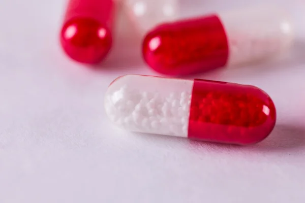 Red-white capsules on a white background