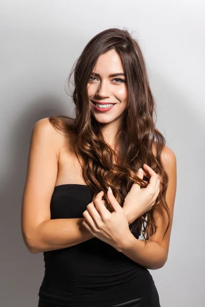 Student smiling brunette with white teeth on a white background
