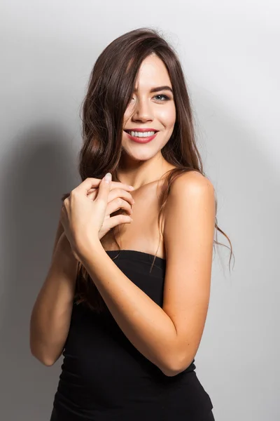 Student smiling brunette with white teeth on a white background