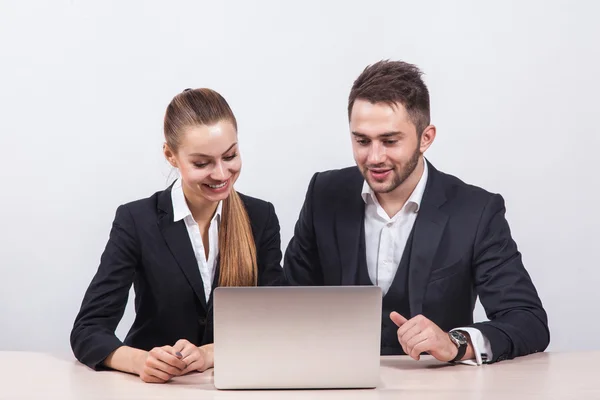 Team of young business man and a woman sitting at computer and l
