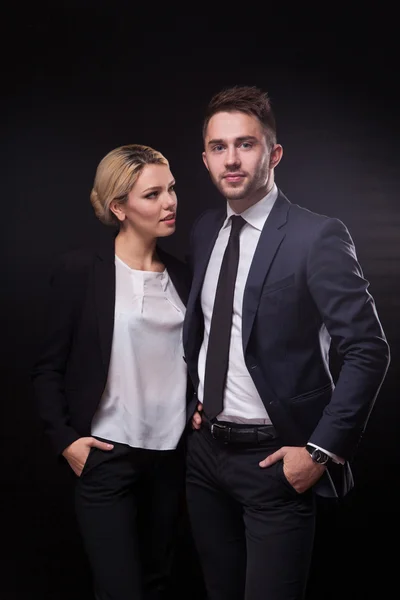 Stylish, trendy and modern business man and woman on black backg