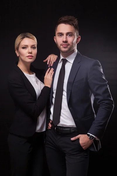 Stylish, trendy and modern business man and woman on black backg