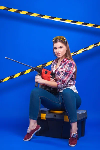 Plus-size model on a blue background with the construction of th