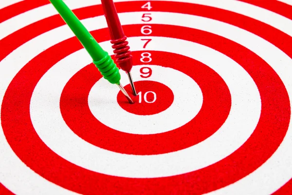 Red dart target with red and green arrows  Close up