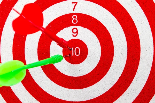 Red dart target with red and green arrows  Close up