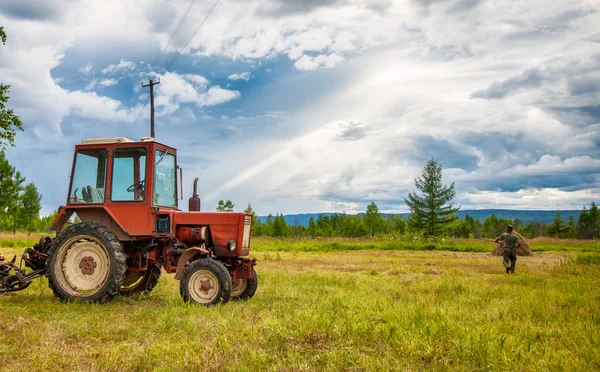 Agrimotor in the field with hay