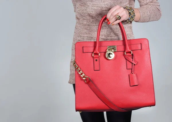 Red stylish glamorous female leather bag on pure background