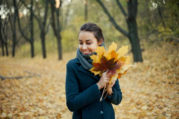 Autumn walk girl in the coat in woods