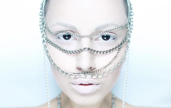 Girl with chain on her face in white