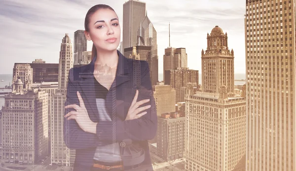 Double exposure of city and beautiful business woman folded her arms