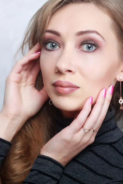 Fashion model with bright makeup and manicure on hands