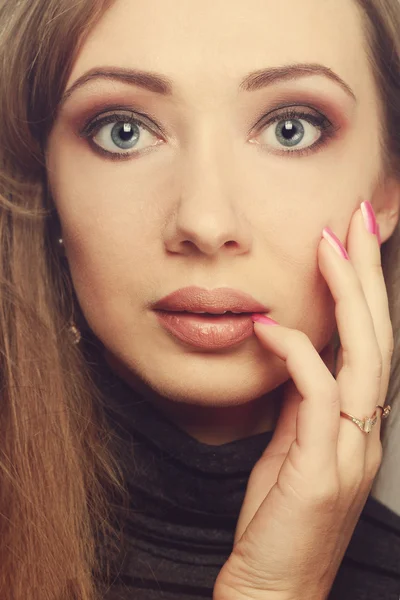 Fashion model with bright makeup and manicure on hands