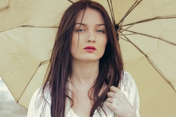 Sad Woman with Umbrella on a Rainy Day