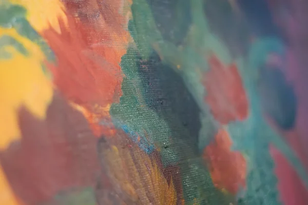 Artist mixes oil paints on pallet with various colors