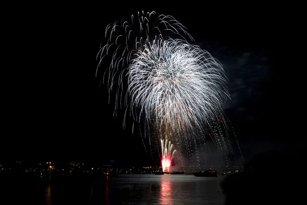 Fireworks summer night over the water of the river