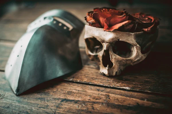 Faded roses in a skull and a visor