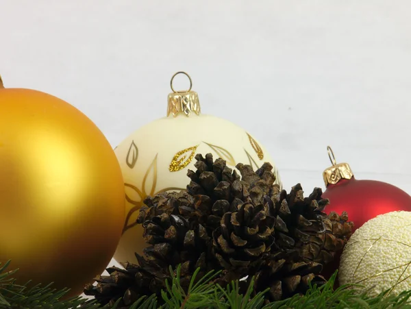 Red and gold Christmas Tree bauble and twig of pine