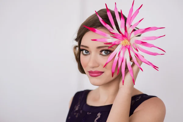 Girl with make-up and a flower smile