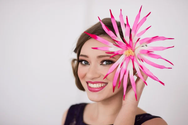 Girl with make-up and a flower smile