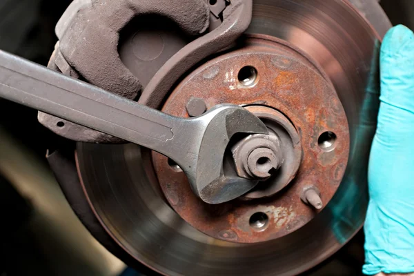 Man repairing car disc brakes
