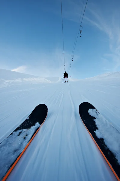 Person on ski lift in mountains