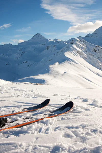 Skis in snow in mountains